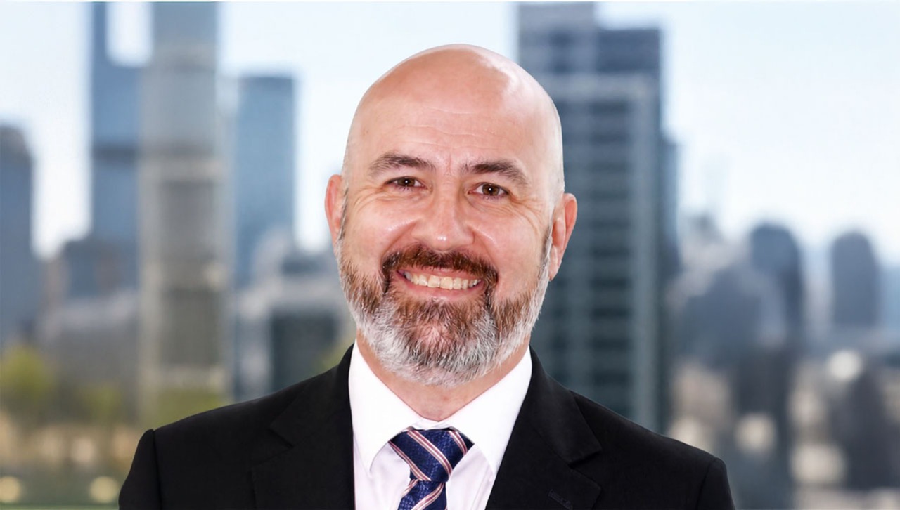 A headshot of Andrew Rhodes